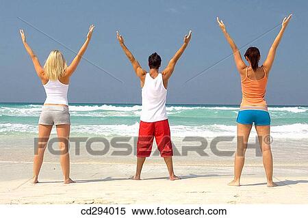 Stock Photography - back view, companion, beach, Arms raised. Fotosearch