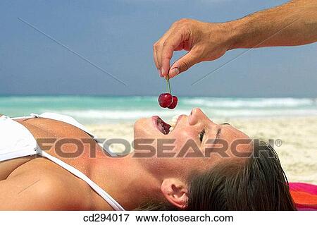 Stock Photo - beach, cherry, brunette, 30's. Fotosearch