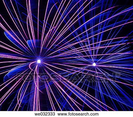 Stock Image - Blue lavendar streamers and fans from firework. Fotosearch