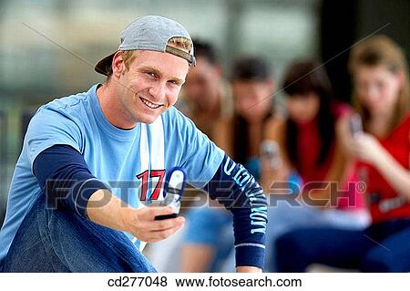 Stock Photo - boy, cap, camera, adolescence. Fotosearch