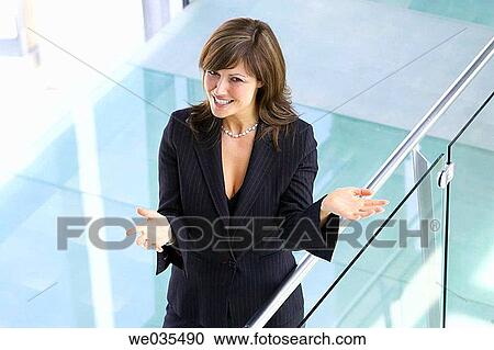 Stock Image - brunette, businesswoman, businesspeople, business, Arms open. Fotosearch