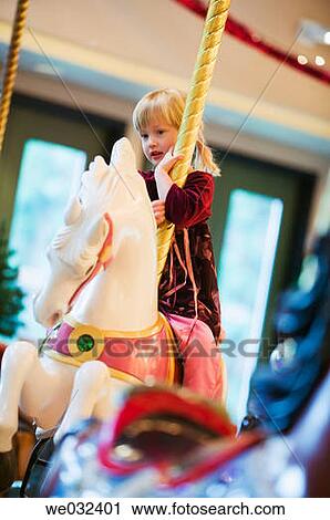 Stock Image - Burnaby Heritage Village Carousel, 4 year old Caucasian girl. Fotosearch