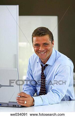 Stock Image - business, casual, businesspeople, businessman, at-home. Fotosearch