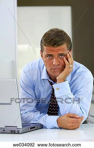 Stock Image - business, casual, businesspeople, businessman, at-home. Fotosearch
