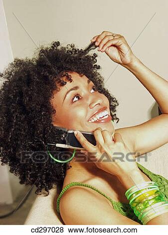 Stock Photo - calling, chat, cell phone, at-home. Fotosearch