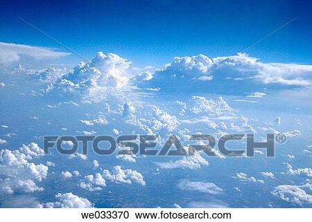 Stock Image - Cloudy sky as viewed from an airplane window. Fotosearch