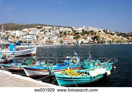 Colorful fishing boats and pleasure craft in the harbor at Samos or Vathi village on the island of Samos, Greece. View Large Photo Image Stock Photo - Colorful fishing boats and pleasure craft in the harbor at Samos or Vathi village on the island of Samos, Greece.. Fotosearch
