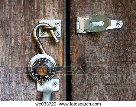 Combination lock hanging open on an old shed door View Large Photo Image Stock Image - Combination lock hanging open on an old shed door. Fotosearch