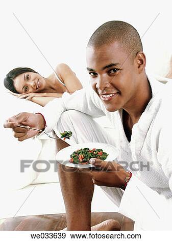 Stock Photo - contemporary, couple, dish, eating. Fotosearch