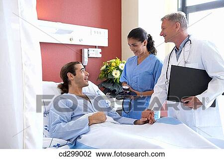 Stock Image - Doctors and patient in hospitalization. Fotosearch