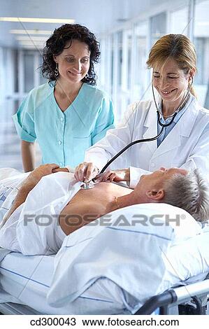 Doctors and patient in hospitalization View Large Photo Image Stock Image - Doctors and patient in hospitalization. Fotosearch
