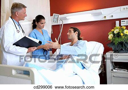 Doctors and patient in hospitalization View Large Photo Image Stock Photograph - Doctors and patient in hospitalization. Fotosearch