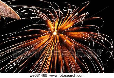 Stock Photography - Gold and white fireworks in night sky. Fotosearch