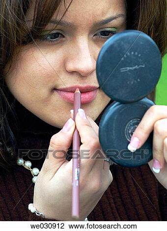 Hispanic woman putting on makeup View Large Photo Image Stock Image - Hispanic woman putting on makeup. Fotosearch