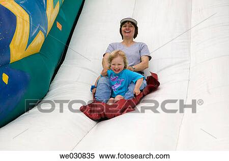 Mom (late 30s) and daughter (3 yrs) on inflatable slide View Large Photo Image Stock Photography - Mom (late 30s) and daughter (3 yrs) on inflatable slide. Fotosearch