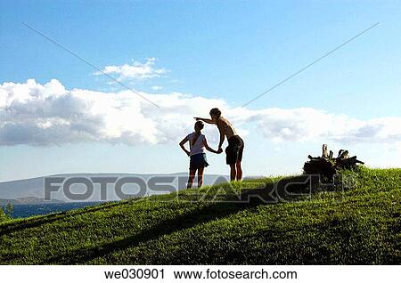 Stock Image - Mother and daughter looking at ocean. Fotosearch