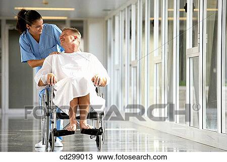 Nurse pushing patient in wheelchair View Large Photo Image Stock Image - Nurse pushing patient in wheelchair. Fotosearch