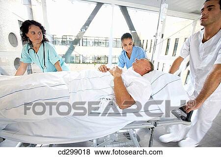 Nurses carrying patient View Large Photo Image Stock Photo - Nurses carrying patient. Fotosearch