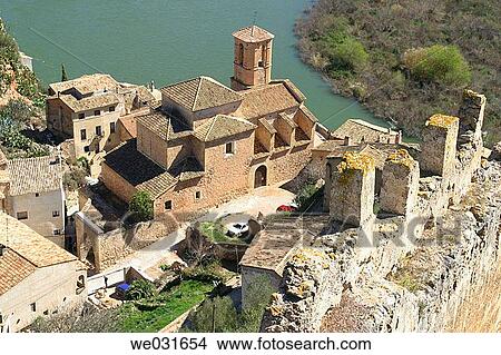 Overview of Miravet parish church and Ebre river. Tarragona province. Catalunya. Spain View Large Photo Image Picture - Overview of Miravet parish church and Ebre river. Tarragona province. Catalunya. Spain. Fotosearch