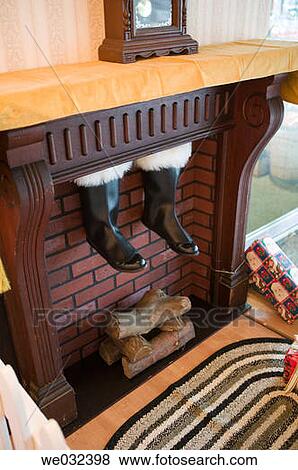 Santa's boots coming down chimney View Large Photo Image Stock Photo - Santa's boots coming down chimney. Fotosearch