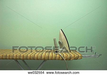 Simple iron on ironing board View Large Photo Image Picture - Simple iron on ironing board. Fotosearch