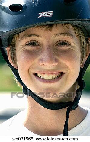 Stock Photography - Smiling boy wearing bike helmet. Fotosearch