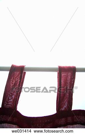 Soft focus of red curtain hanging on white rod in front of window View Large Photo Image Picture - Soft focus of red curtain hanging on white rod in front of window. Fotosearch