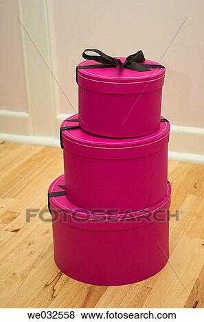 Stack of three pink gift boxes on a wooden floor View Large Photo Image Stock Photo - Stack of three pink gift boxes on a wooden floor. Fotosearch