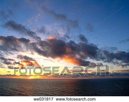 Stock Photo - Sunset over the North Sea, dramatic cloud formations. Fotosearch