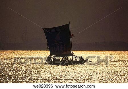 Stock Photograph - Sunset. Sailboat. Jakarta. Indonesia.. Fotosearch