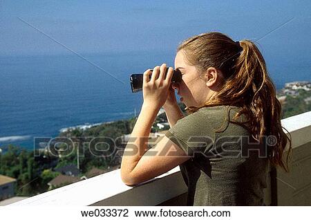 Teenage girl looking at the Pacific Ocean with Binoculars. Laguna Beach, California View Large Photo Image Stock Image - Teenage girl looking at the Pacific Ocean with Binoculars. Laguna Beach, California. Fotosearch