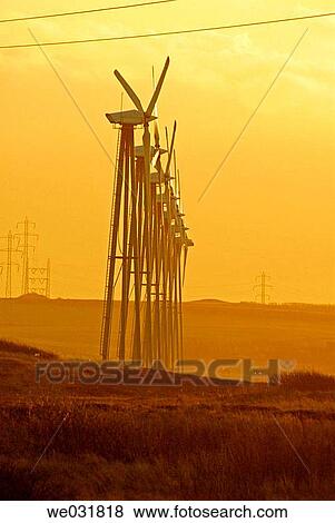 The haze and the low winter sun gives the windpark and the landscape and eiry feel and glow to it. View Large Photo Image Stock Photo - The haze and the low winter sun gives the windpark and the landscape and eiry feel and glow to it.. Fotosearch