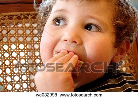 Toddler eating View Large Photo Image Stock Photo - Toddler eating. Fotosearch