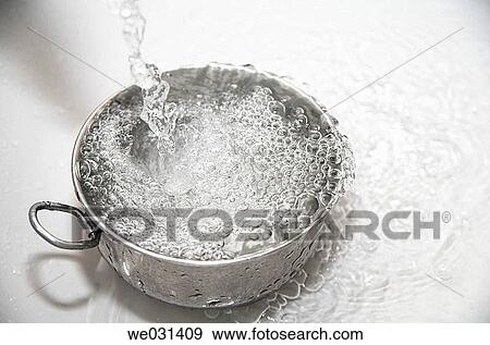 Water pours into stainless steel bowl View Large Photo Image Stock Photo - Water pours into stainless steel bowl. Fotosearch