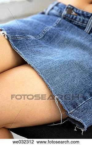 Stock Image - Woman's sexy legs with short skirt. Fotosearch