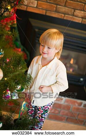 Young girl decorating Christmas tree View Large Photo Image Picture - Young girl decorating Christmas tree. Fotosearch