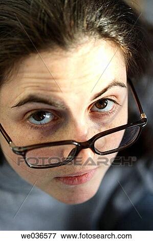 20? s-30's caucasian woman peering over her glasses View Large Photo Image Stock Photo - 20? s-30's caucasian woman peering over her glasses. Fotosearch