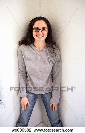 Stock Image - 20? s-30's caucasian woman standing in corner. Fotosearch
