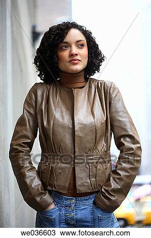 Stock Image - 20's sexy latino/african american woman looking off to the future. Fotosearch