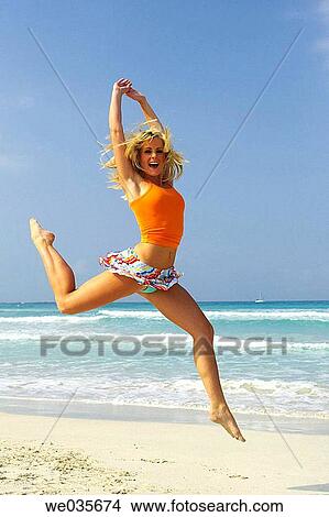 agility, blond, beach, Arms raised, agile View Large Photo Image Picture - agility, blond, beach, Arms raised, agile. Fotosearch