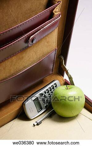 Apple and mobile phone in briefcase View Large Photo Image Stock Image - Apple and mobile phone in briefcase. Fotosearch