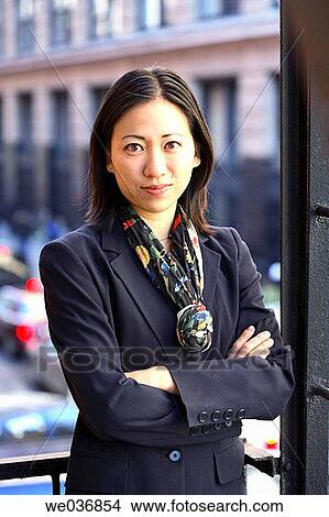 Picture - Asian business woman looking into camera. Fotosearch