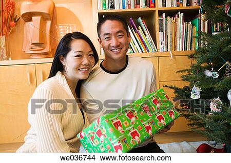 Asian couple with Christmas gifts View Large Photo Image Picture - Asian couple with Christmas gifts. Fotosearch