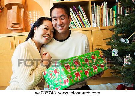 Asian couple with Christmas gifts View Large Photo Image Stock Image - Asian couple with Christmas gifts. Fotosearch