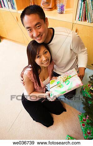 Asian couple with Christmas gifts View Large Photo Image Stock Photo - Asian couple with Christmas gifts. Fotosearch