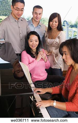 Asian Friends Sitting Around a Piano View Large Photo Image Stock Image - Asian Friends Sitting Around a Piano. Fotosearch