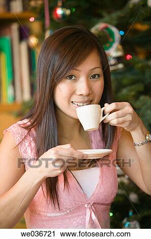 Stock Image - Asian woman with an espresso cup. Fotosearch