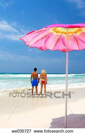Stock Photo - back view, beach, calm. Fotosearch