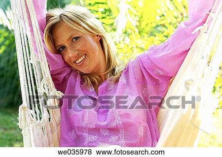 Stock Photo - blond, chilling out, calm, Arms raised. Fotosearch