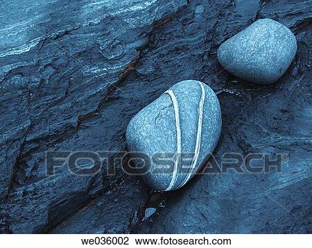 Stock Image - Boulders on the beach.. Fotosearch